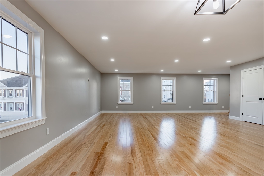214 Horton Street Fall River, MA 02723 - Photo 17 of 40 a view of empty room with wooden floor and fan