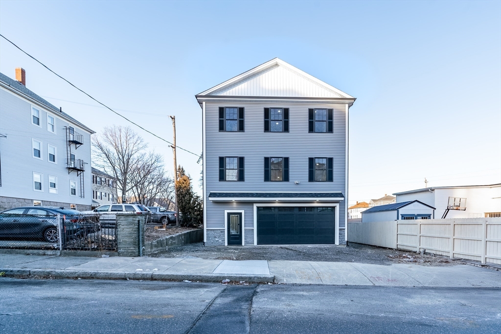 214 Horton Street Fall River, MA 02723 - Photo 2 of 40 a front view of a house with a yard