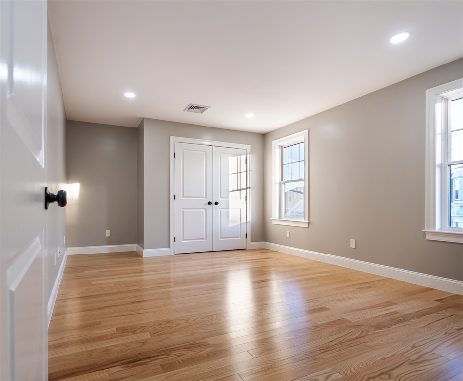 214 Horton Street Fall River, MA 02723 - Photo 23 of 40 a view of an empty room with wooden floor and a window