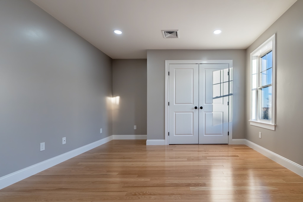 214 Horton Street Fall River, MA 02723 - Photo 24 of 40 an empty room with wooden floor and windows