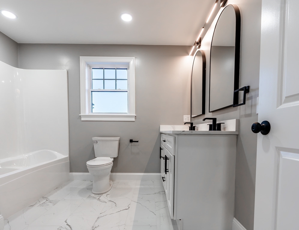 214 Horton Street Fall River, MA 02723 - Photo 28 of 40 a bathroom with a toilet sink and mirror