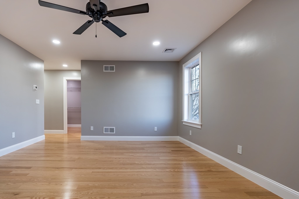 214 Horton Street Fall River, MA 02723 - Photo 33 of 40 an empty room with wooden floor and windows