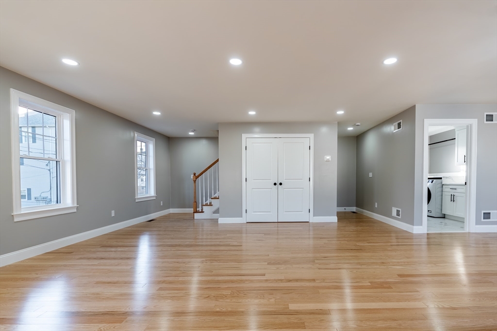 214 Horton Street Fall River, MA 02723 - Photo 8 of 40 a view of an empty room with wooden floor and a window