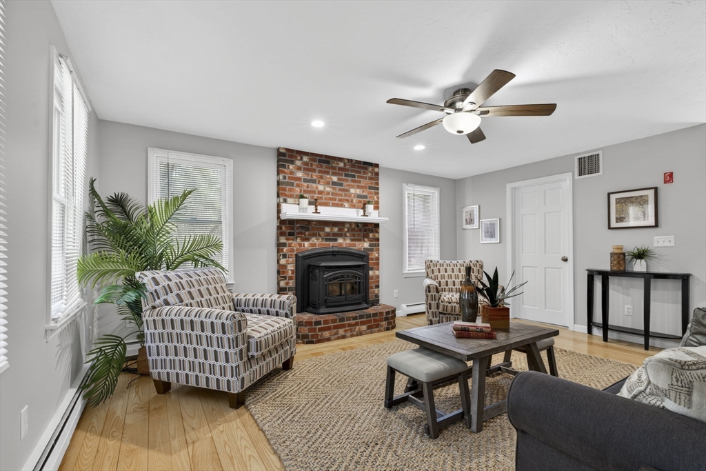 111 Goss Lane Lancaster, MA 01523 - Photo 12 of 39 a living room with furniture and a fireplace