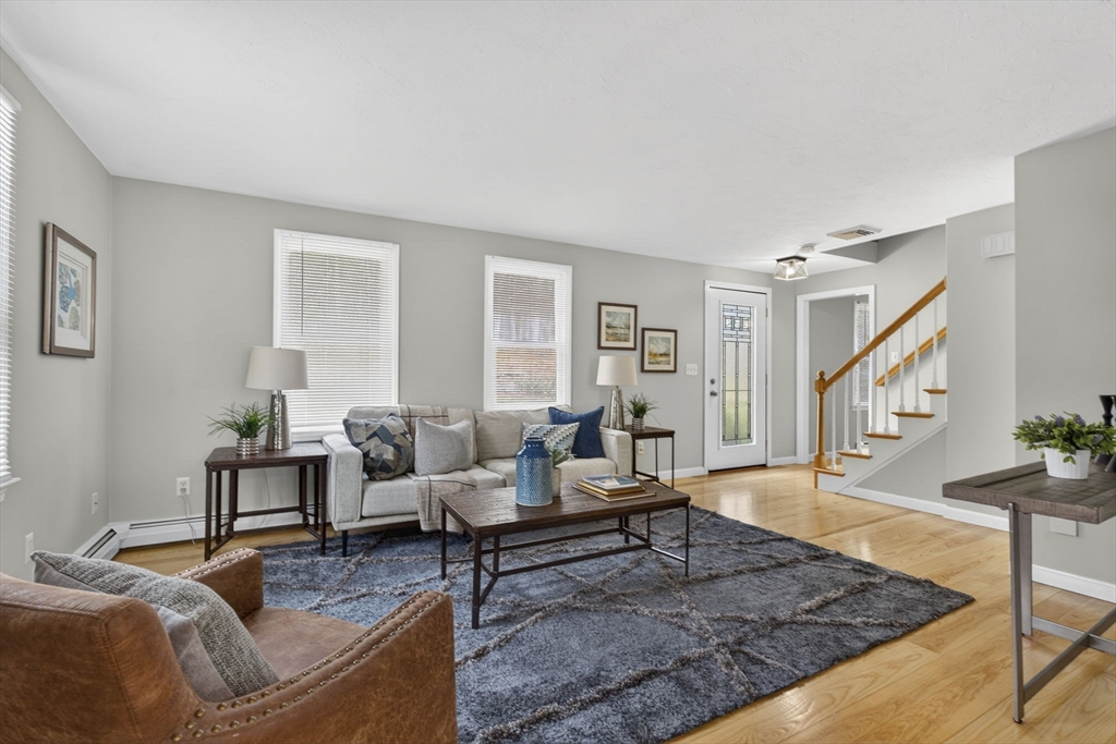 111 Goss Lane Lancaster, MA 01523 - Photo 15 of 39 a living room with furniture and a rug