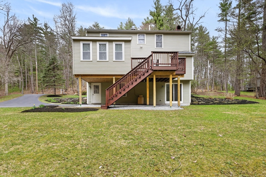 111 Goss Lane Lancaster, MA 01523 - Photo 2 of 39 a view of a house with a swimming pool and a yard