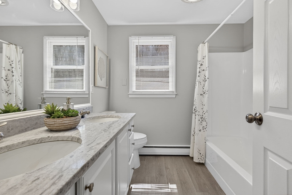 111 Goss Lane Lancaster, MA 01523 - Photo 23 of 39 a bathroom with a granite countertop tub a sink and a window