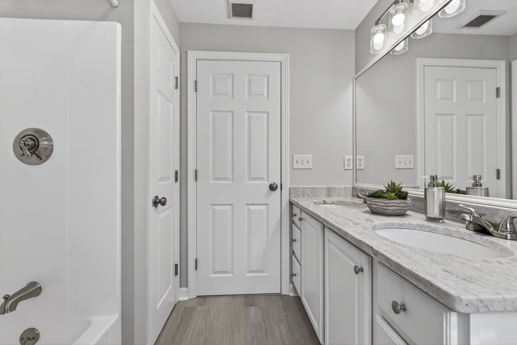 111 Goss Lane Lancaster, MA 01523 - Photo 24 of 39 a spacious bathroom with a granite countertop sink and a mirror