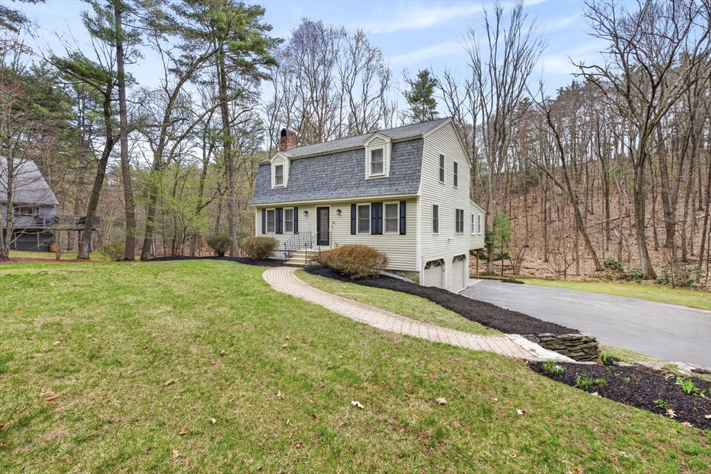 111 Goss Lane Lancaster, MA 01523 - Photo 3 of 39 a front view of a house with a yard and trees