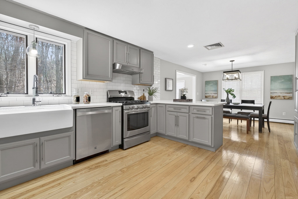 111 Goss Lane Lancaster, MA 01523 - Photo 4 of 39 a kitchen with a sink cabinets and wooden floor
