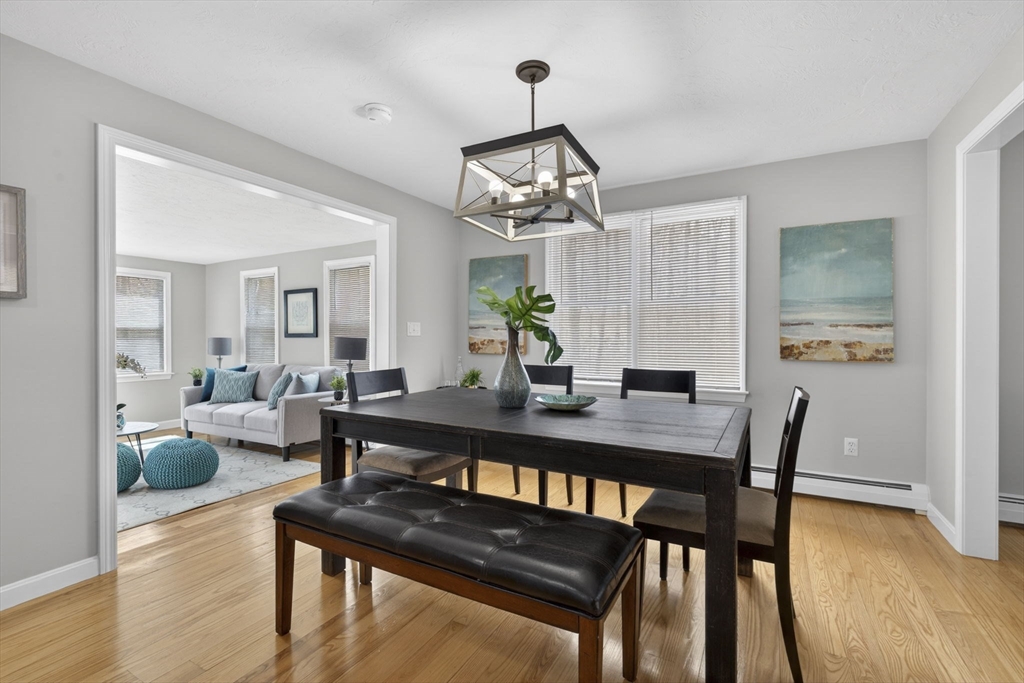 111 Goss Lane Lancaster, MA 01523 - Photo 10 of 39 a view of a dining room with furniture wooden floor and chandelier