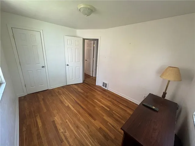 a bed room with a bed and a chair