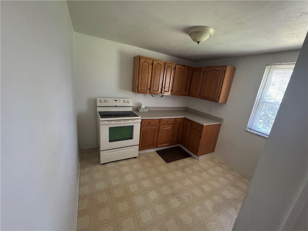 626 Ridgemont Drive Pittsburgh, PA 15220 - Photo 6 of 18 a kitchen with a stove top oven and cabinets