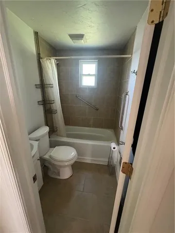 a bathroom with a toilet a sink and a bathtub