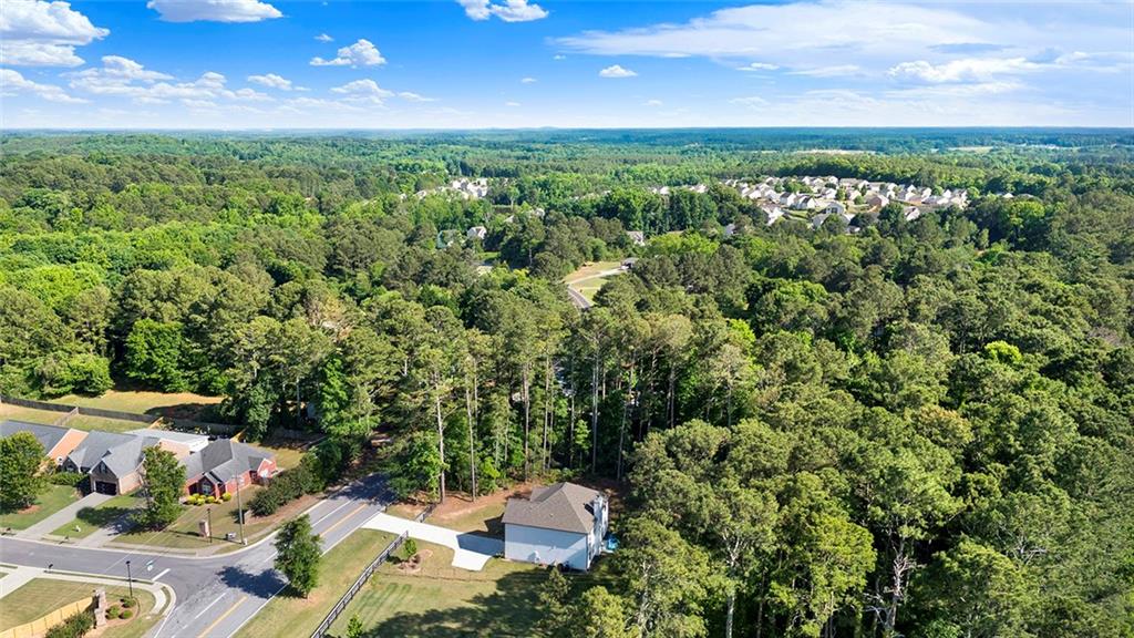 407 Corinth Church Road Winder, GA 30680 - Photo 59 of 66 a view of a city with lush green forest