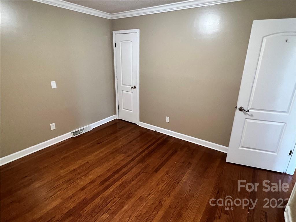 4114 Hartsville-Ruby Road Patrick, SC 29584 - Photo 13 of 48 an empty room with wooden floor and white door