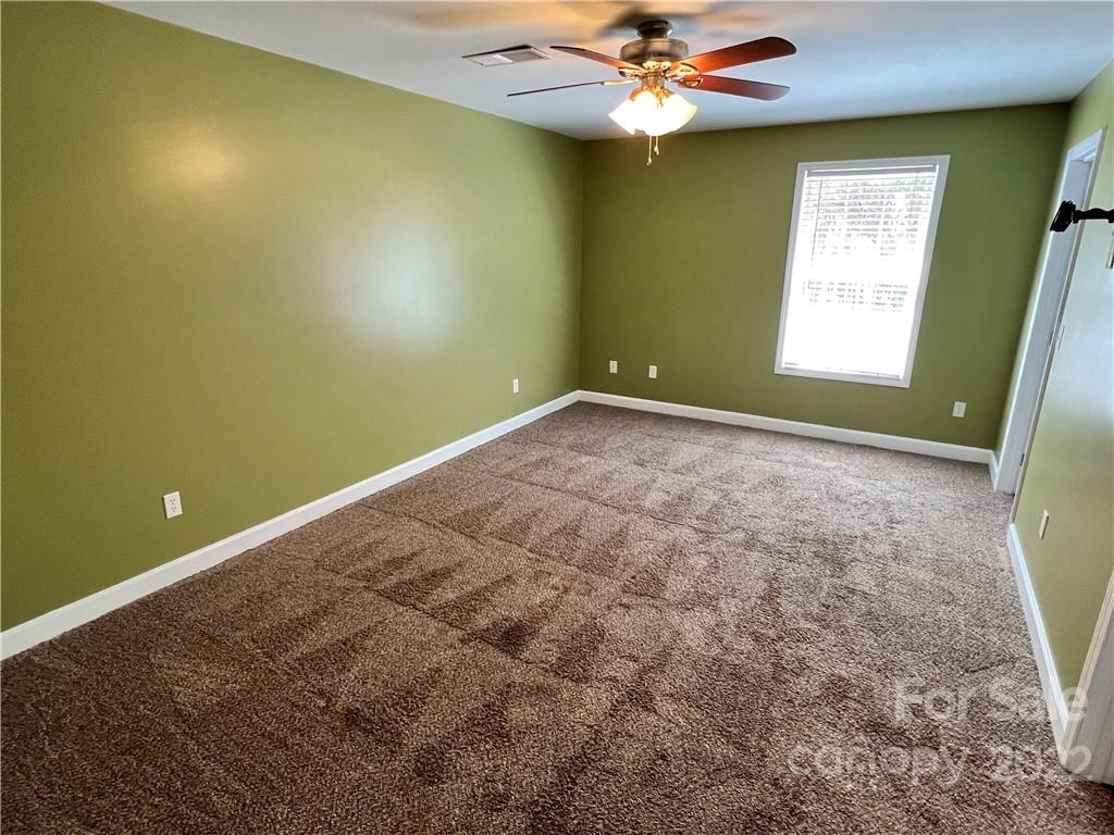 4114 Hartsville-Ruby Road Patrick, SC 29584 - Photo 18 of 48 a view of an empty room with window and chandelier fan