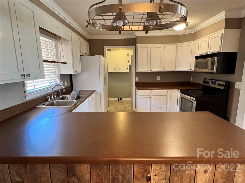 4114 Hartsville-Ruby Road Patrick, SC 29584 - Photo 7 of 48 a view of kitchen with stainless steel appliances granite countertop a stove top oven a sink dishwasher and a microwave