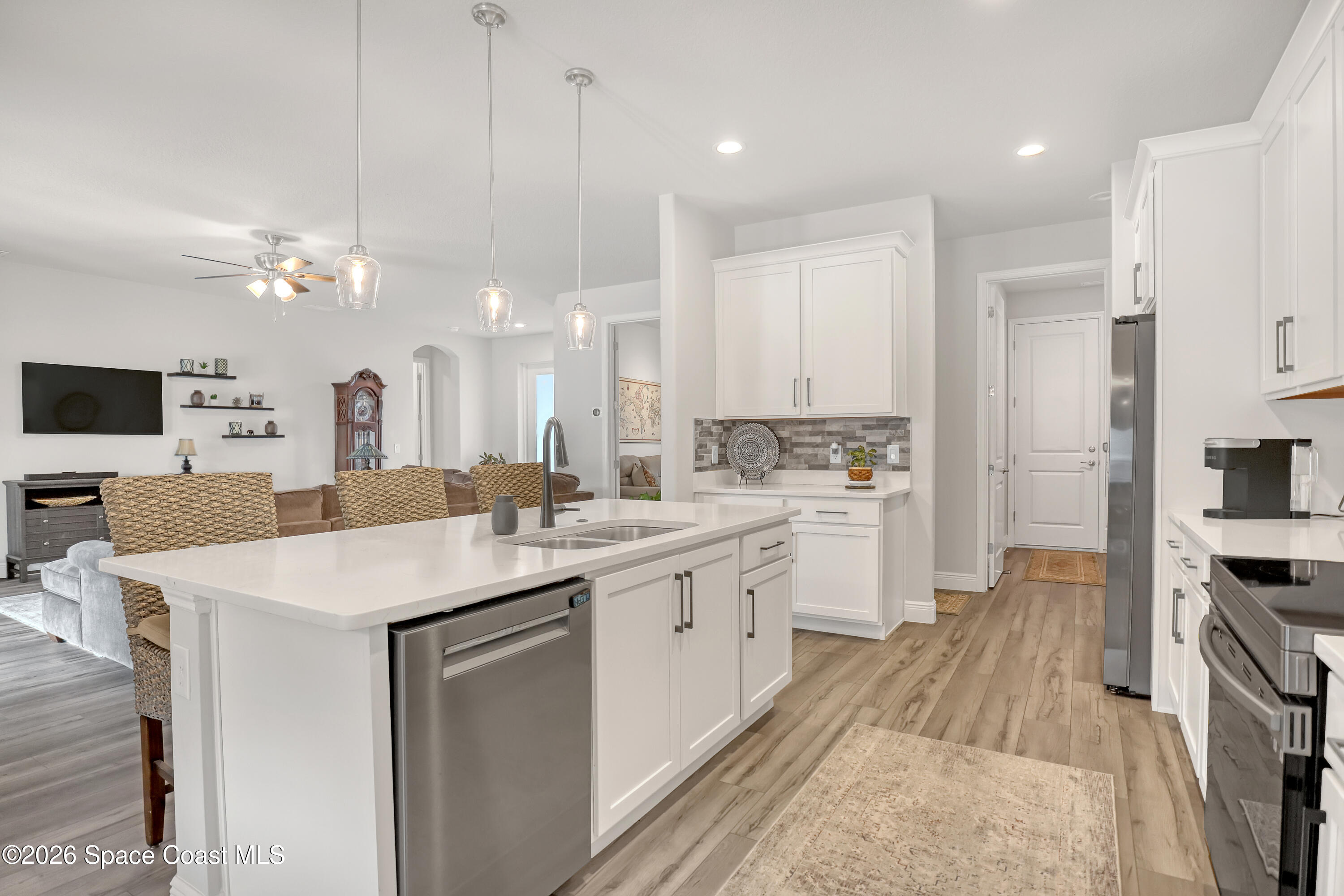 1837 Market Circle Northeast Palm Bay, FL 32905 - Photo 12 of 57 a kitchen with a sink a stove top oven a counter space and cabinets