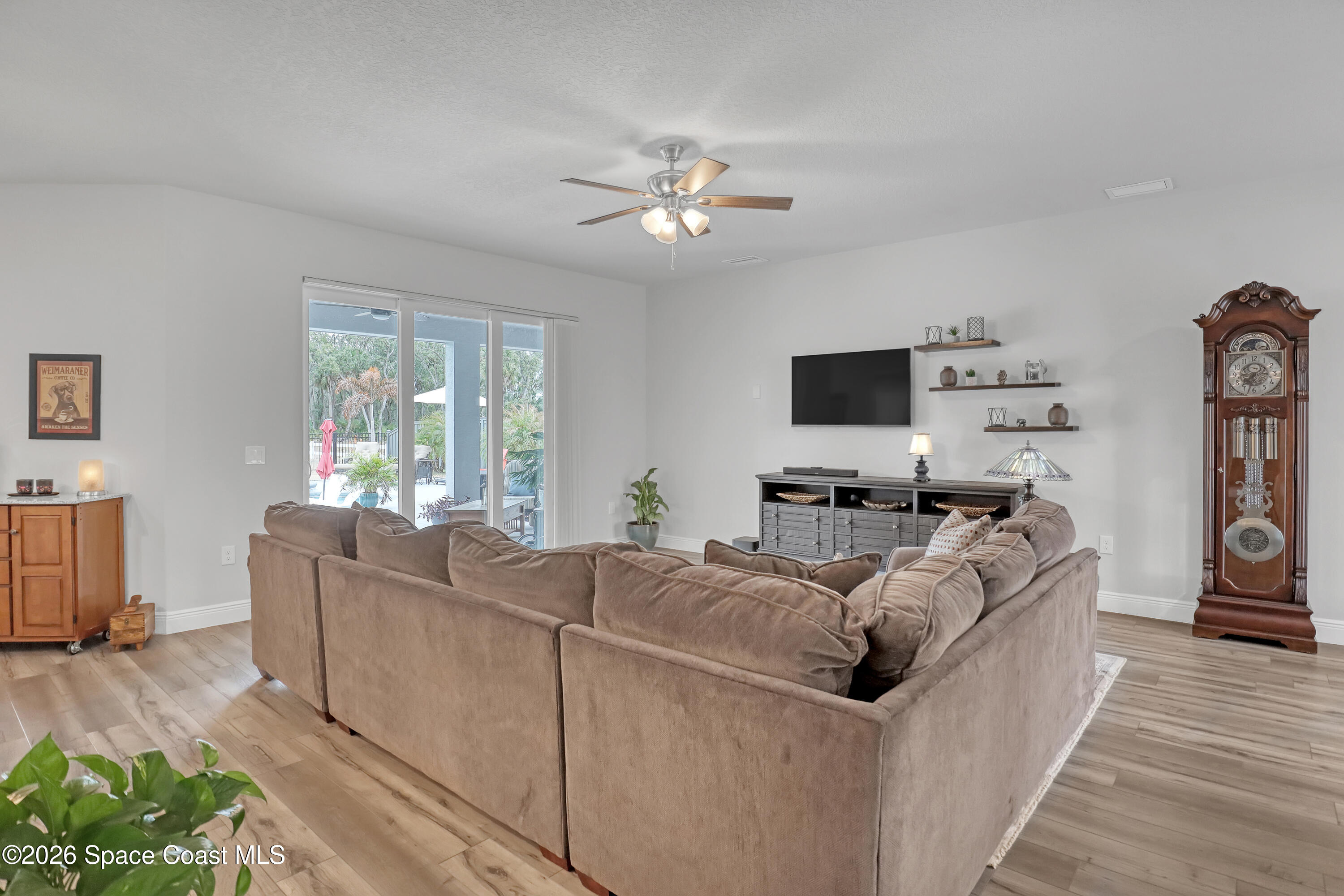 1837 Market Circle Northeast Palm Bay, FL 32905 - Photo 17 of 57 a living room with furniture and a flat screen tv