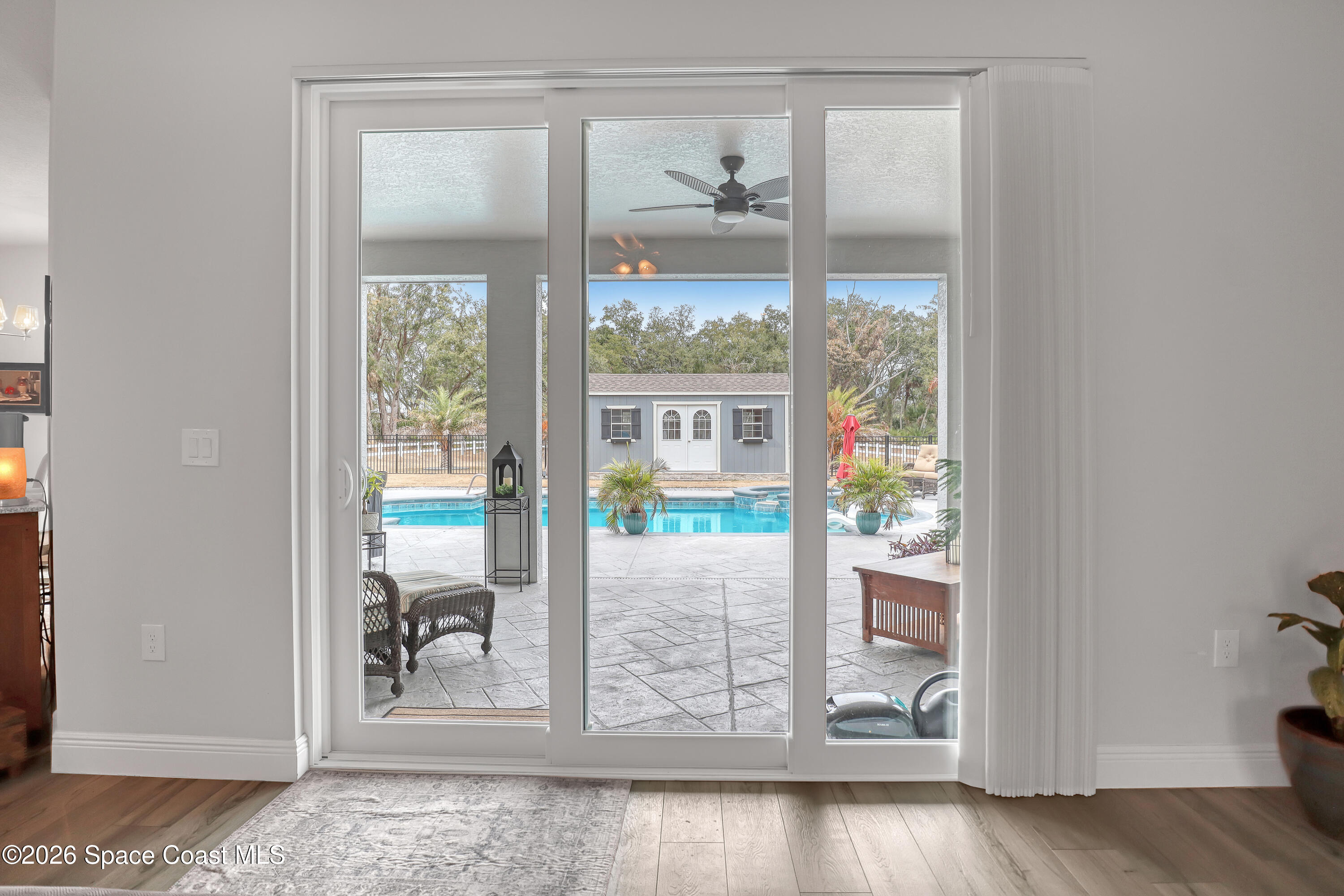 1837 Market Circle Northeast Palm Bay, FL 32905 - Photo 20 of 57 a view of a glass door with wooden floor