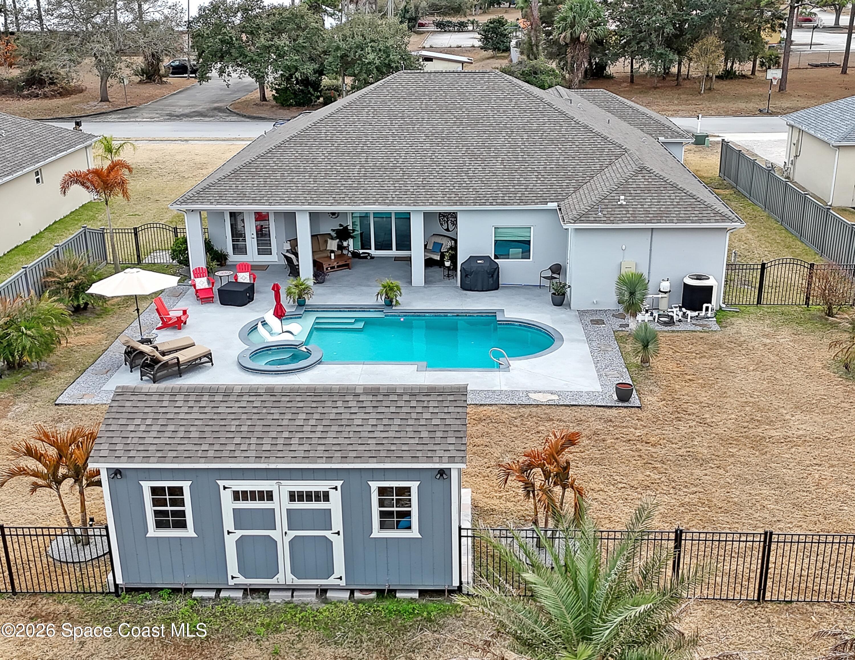 1837 Market Circle Northeast Palm Bay, FL 32905 - Photo 2 of 57 a front view of a house with garden