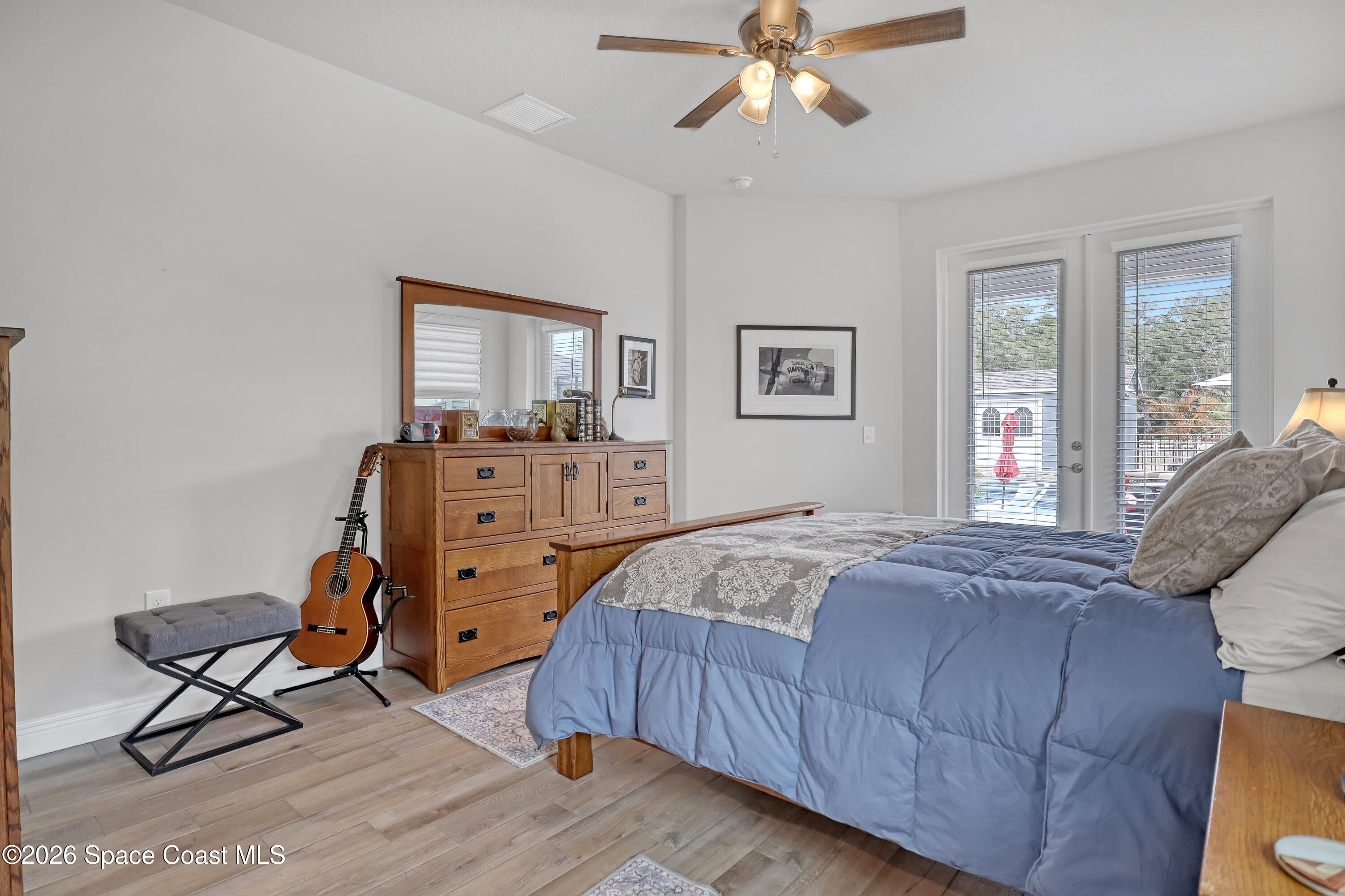1837 Market Circle Northeast Palm Bay, FL 32905 - Photo 22 of 57 a bedroom with a bed and a chandelier