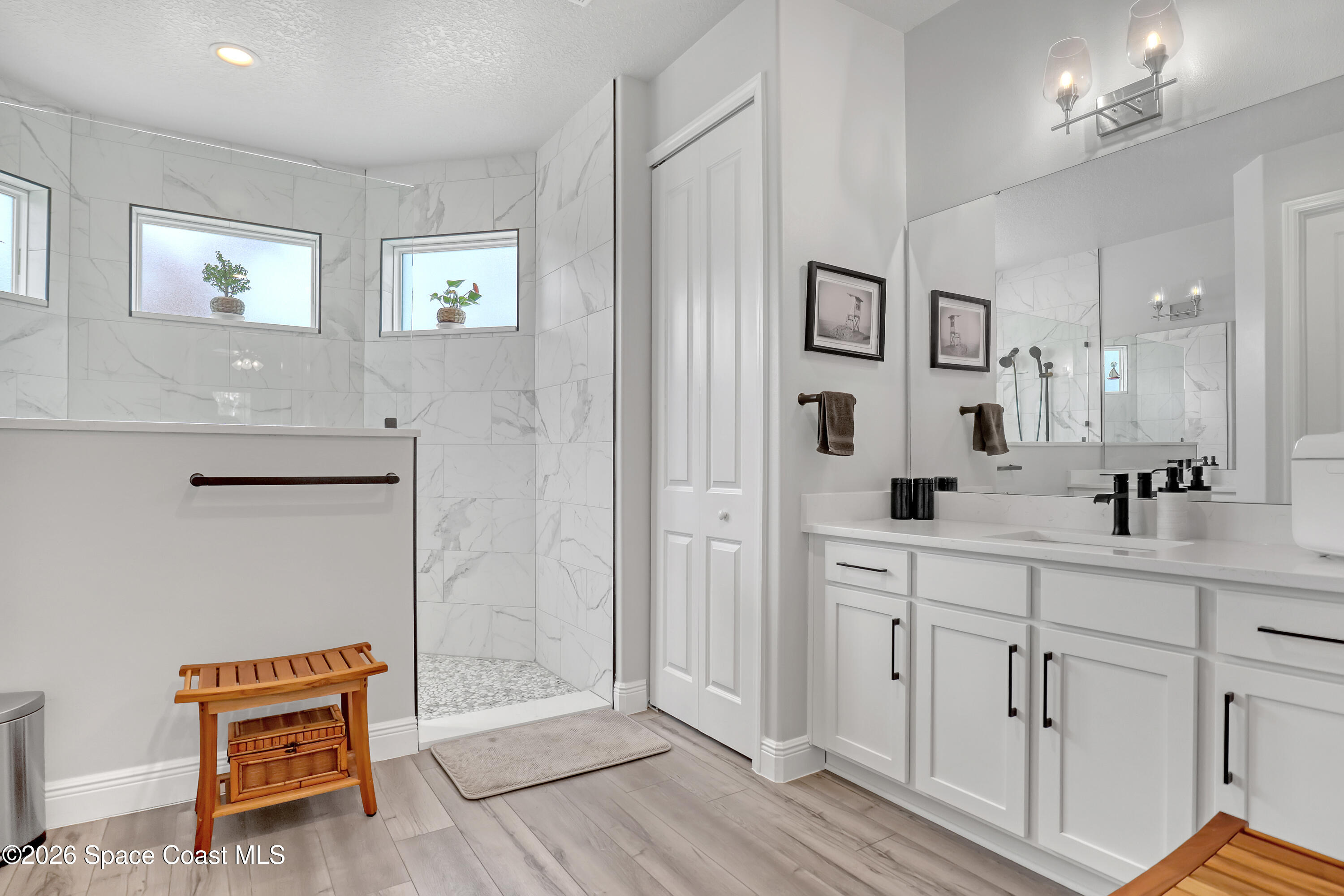 1837 Market Circle Northeast Palm Bay, FL 32905 - Photo 24 of 57 a spacious bathroom with double vanity sink a mirror and a shower