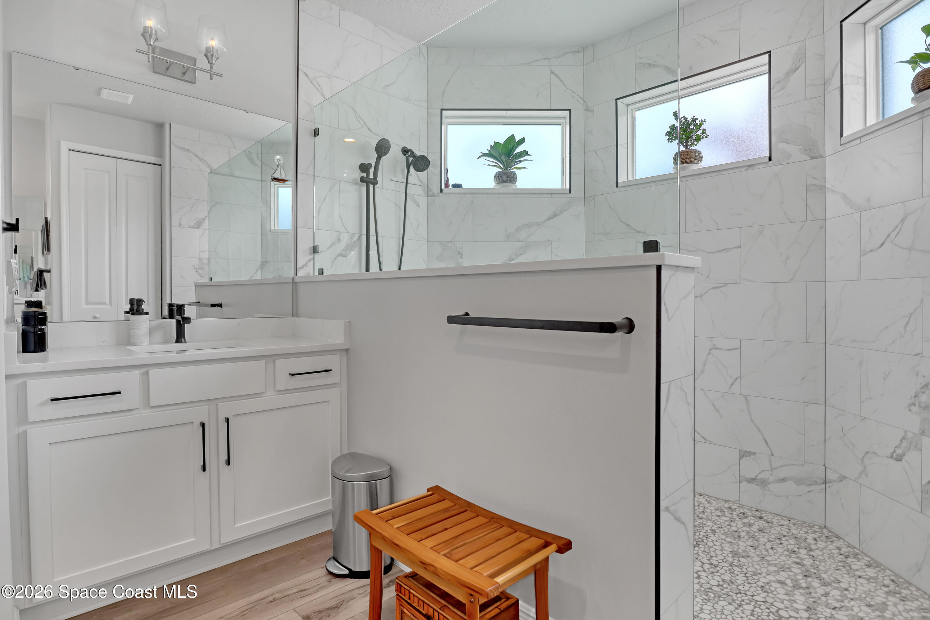 1837 Market Circle Northeast Palm Bay, FL 32905 - Photo 25 of 57 a bathroom with a sink a mirror and a shower