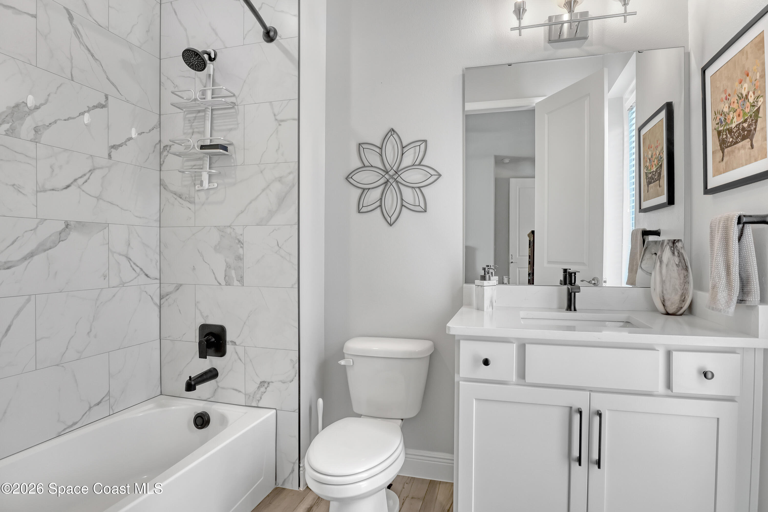 1837 Market Circle Northeast Palm Bay, FL 32905 - Photo 29 of 57 a bathroom with a sink a toilet and shower