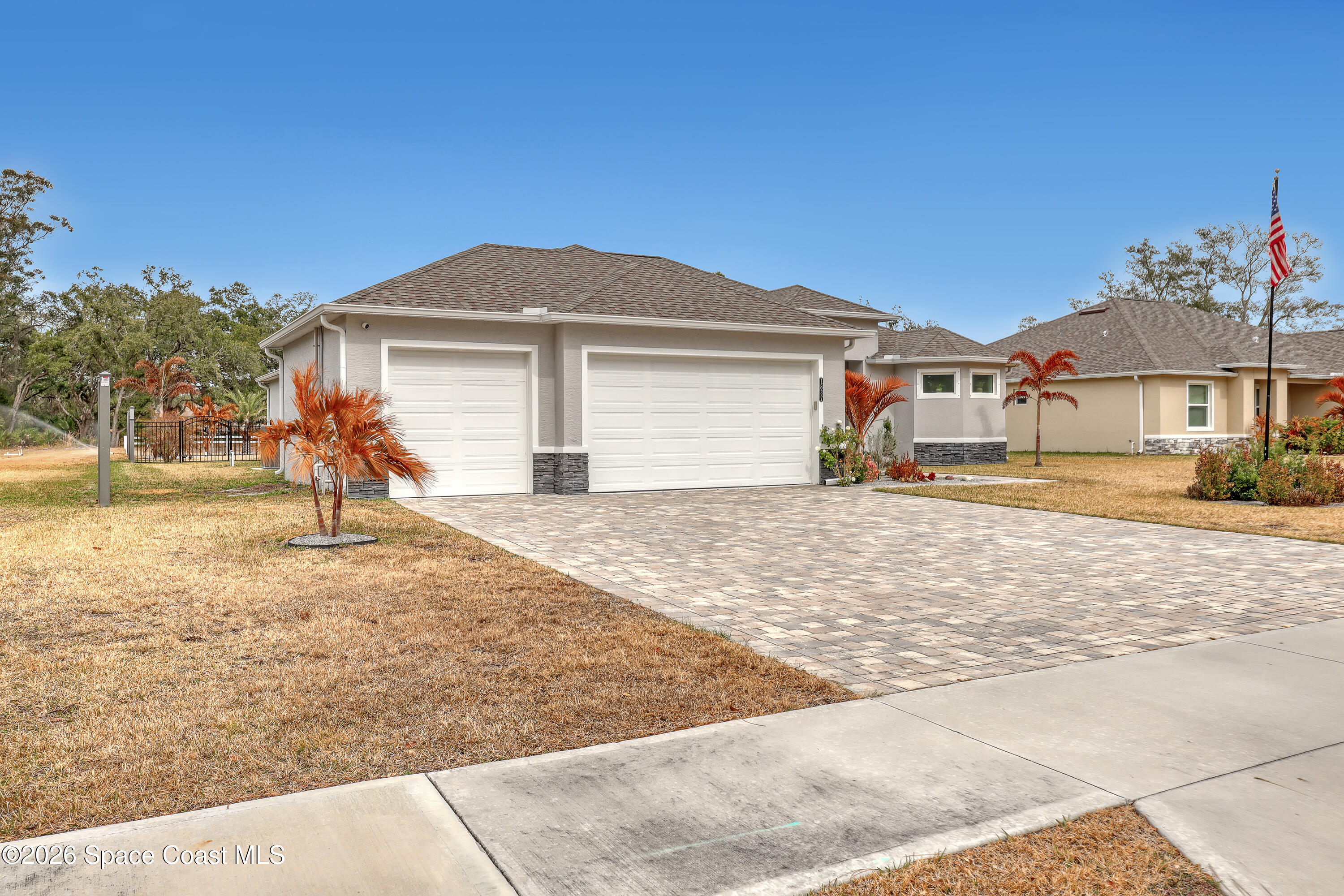 1837 Market Circle Northeast Palm Bay, FL 32905 - Photo 3 of 57 a front view of a house with a yard