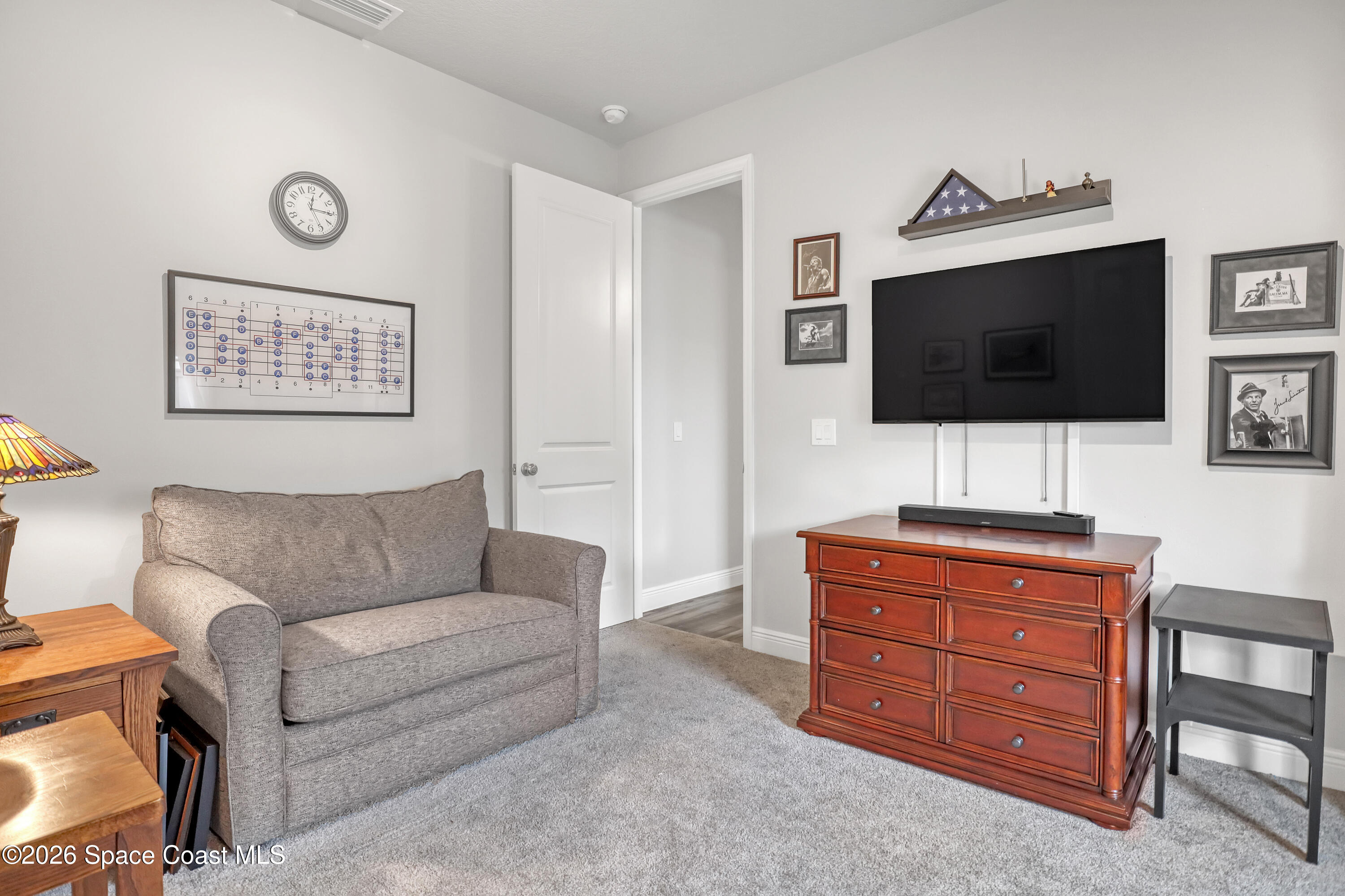 1837 Market Circle Northeast Palm Bay, FL 32905 - Photo 34 of 57 a living room with furniture and a flat screen tv