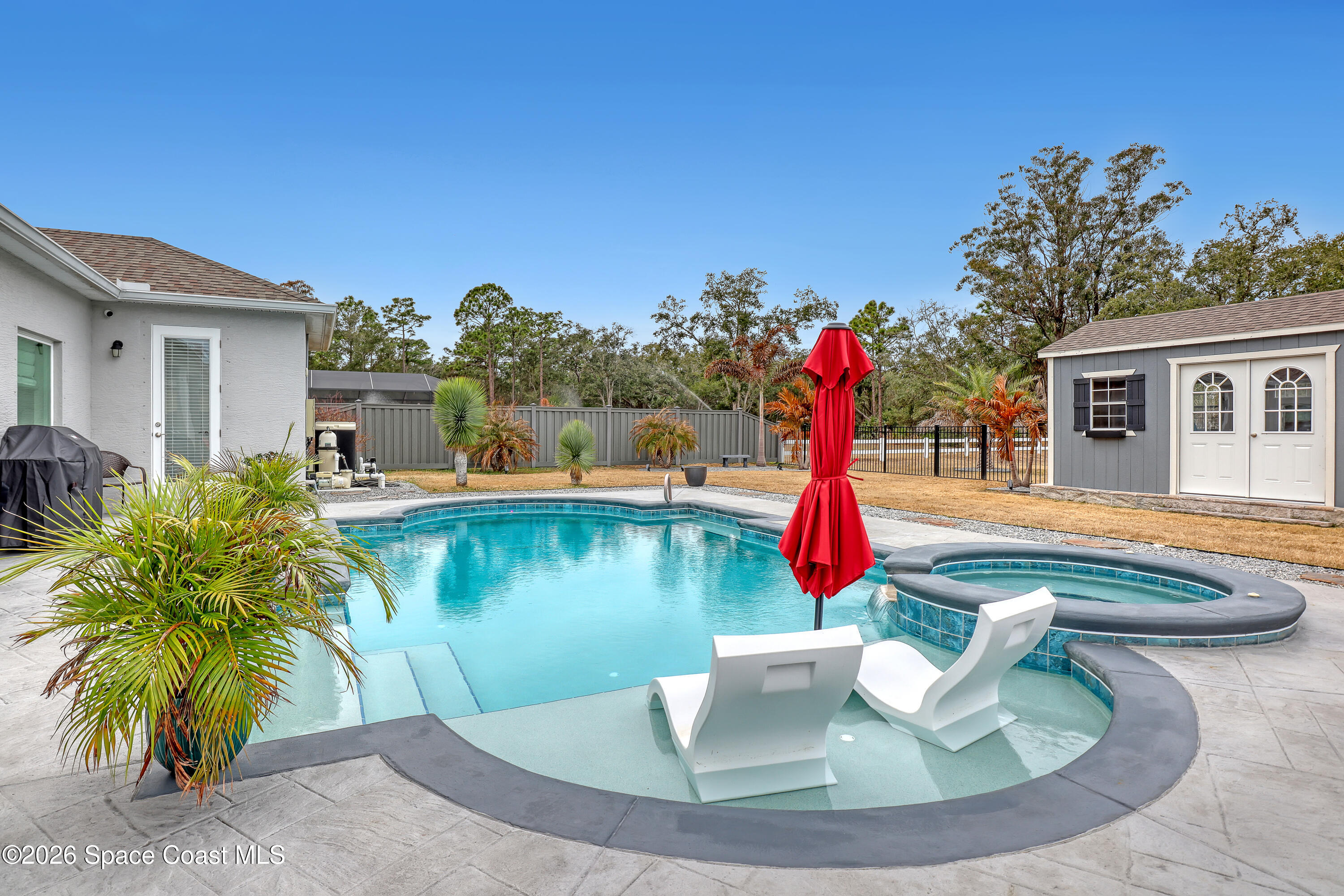 1837 Market Circle Northeast Palm Bay, FL 32905 - Photo 40 of 57 a swimming pool with outdoor seating