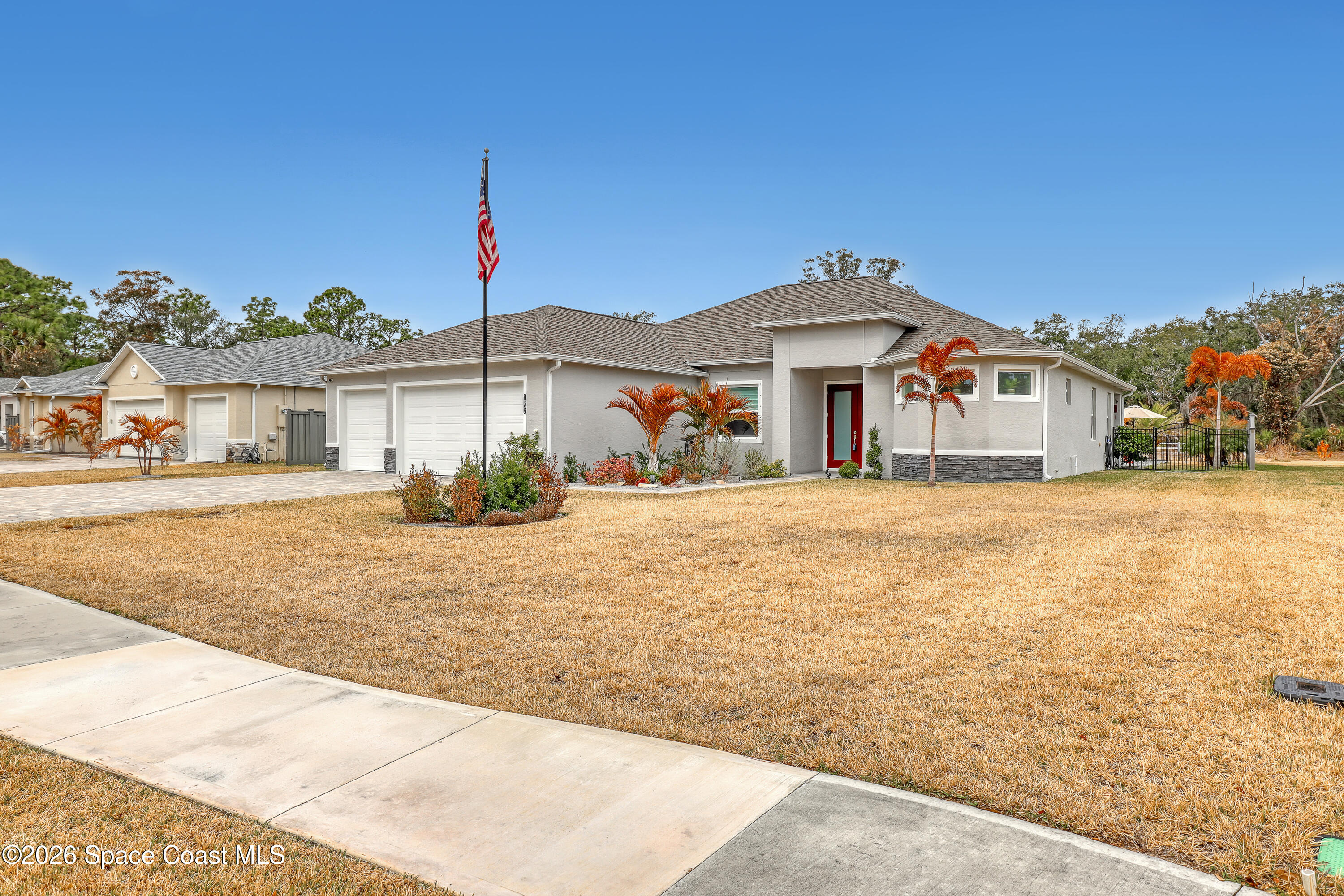 1837 Market Circle Northeast Palm Bay, FL 32905 - Photo 4 of 57 a front view of a house with a yard