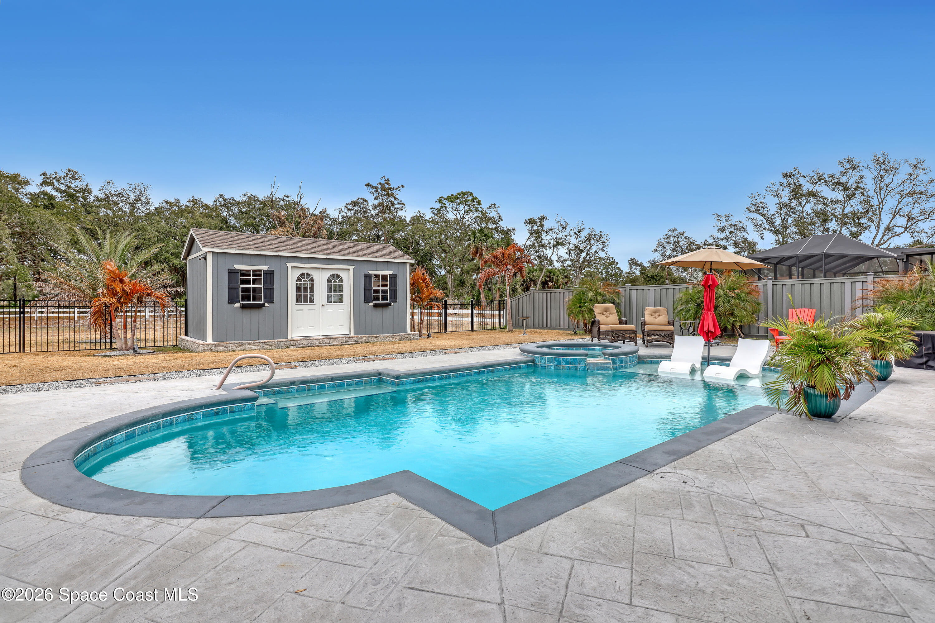 1837 Market Circle Northeast Palm Bay, FL 32905 - Photo 46 of 57 a view of a swimming pool with a patio