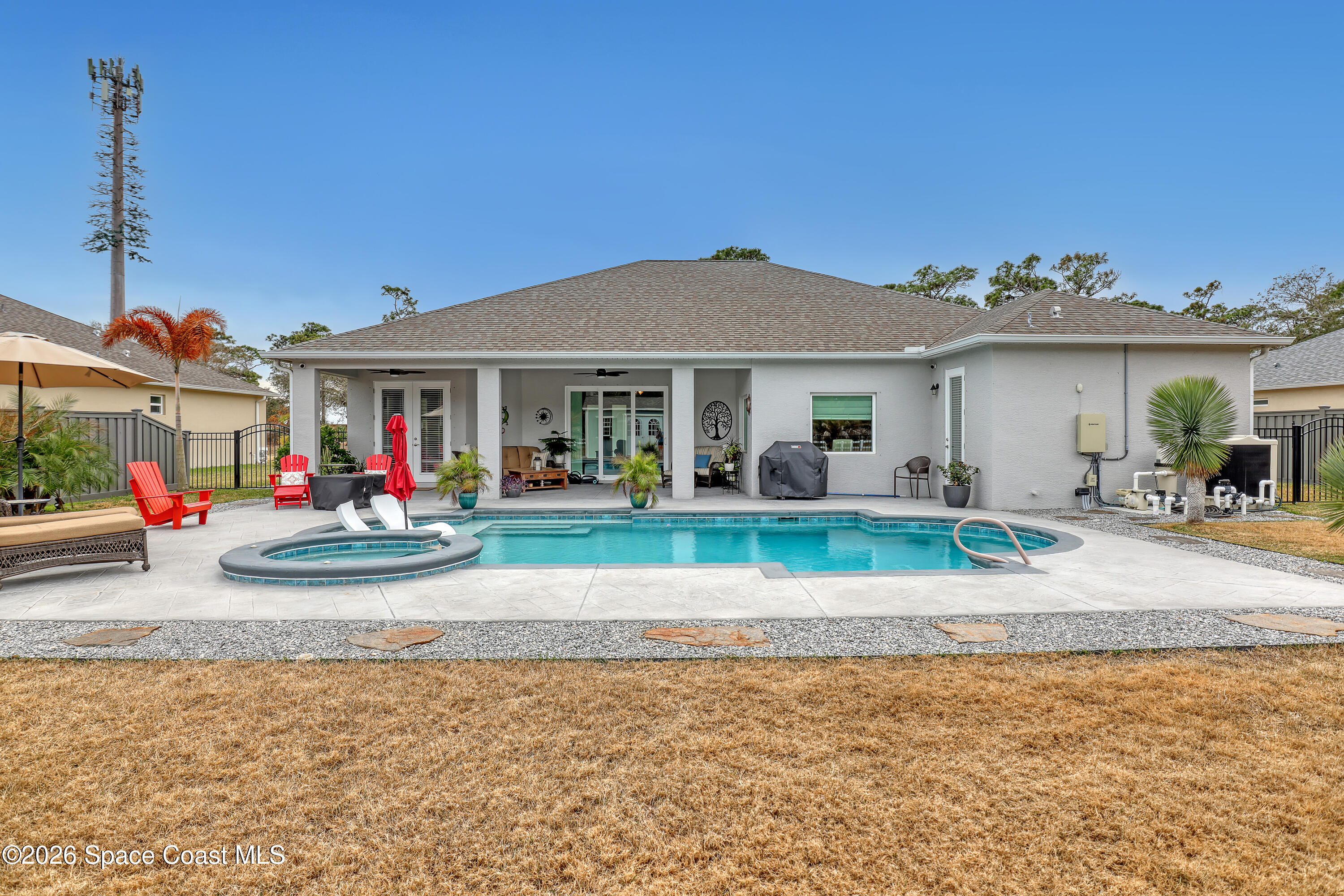 1837 Market Circle Northeast Palm Bay, FL 32905 - Photo 49 of 57 a front view of a house with a yard table and chairs