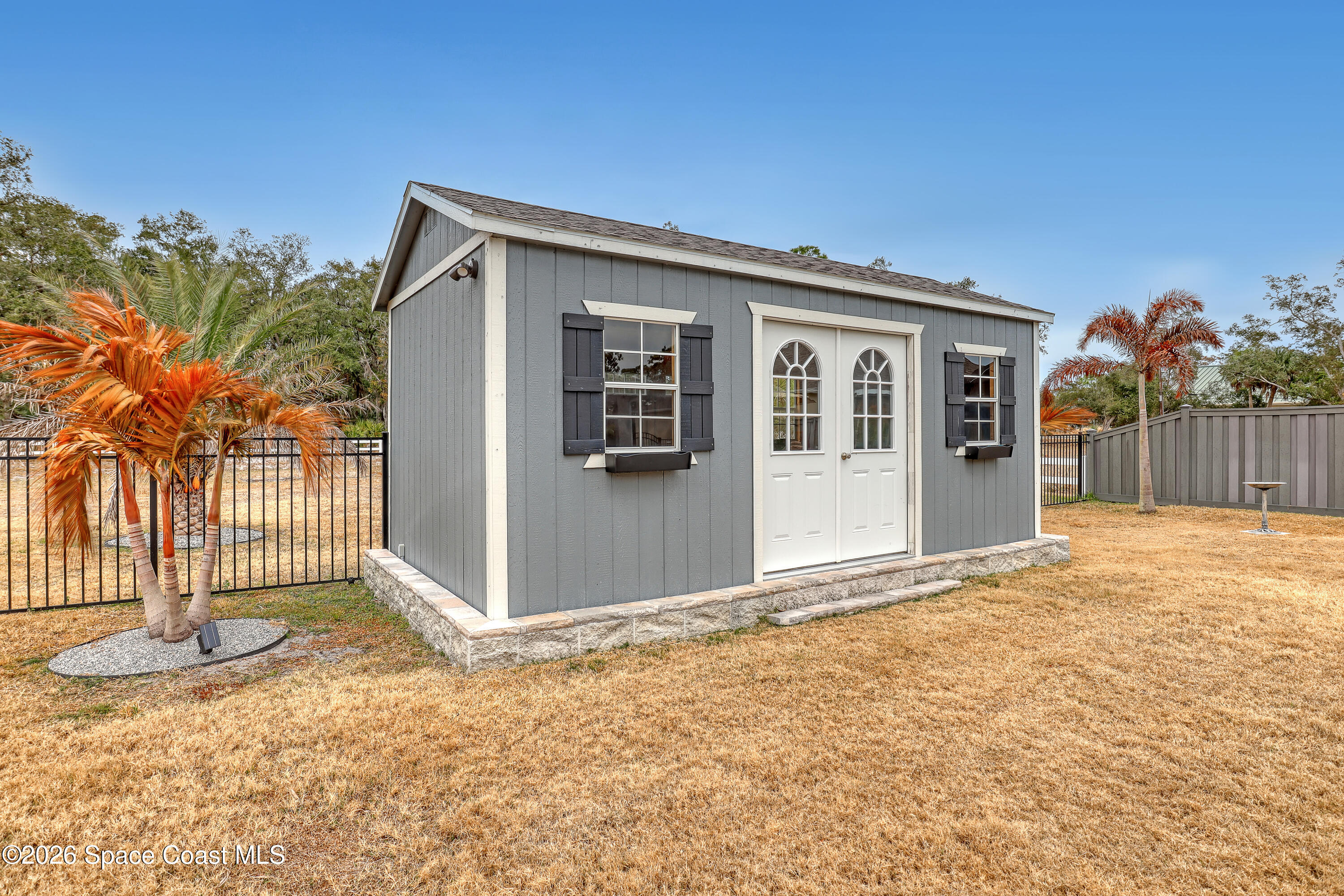 1837 Market Circle Northeast Palm Bay, FL 32905 - Photo 52 of 57 a front view of a house with a yard