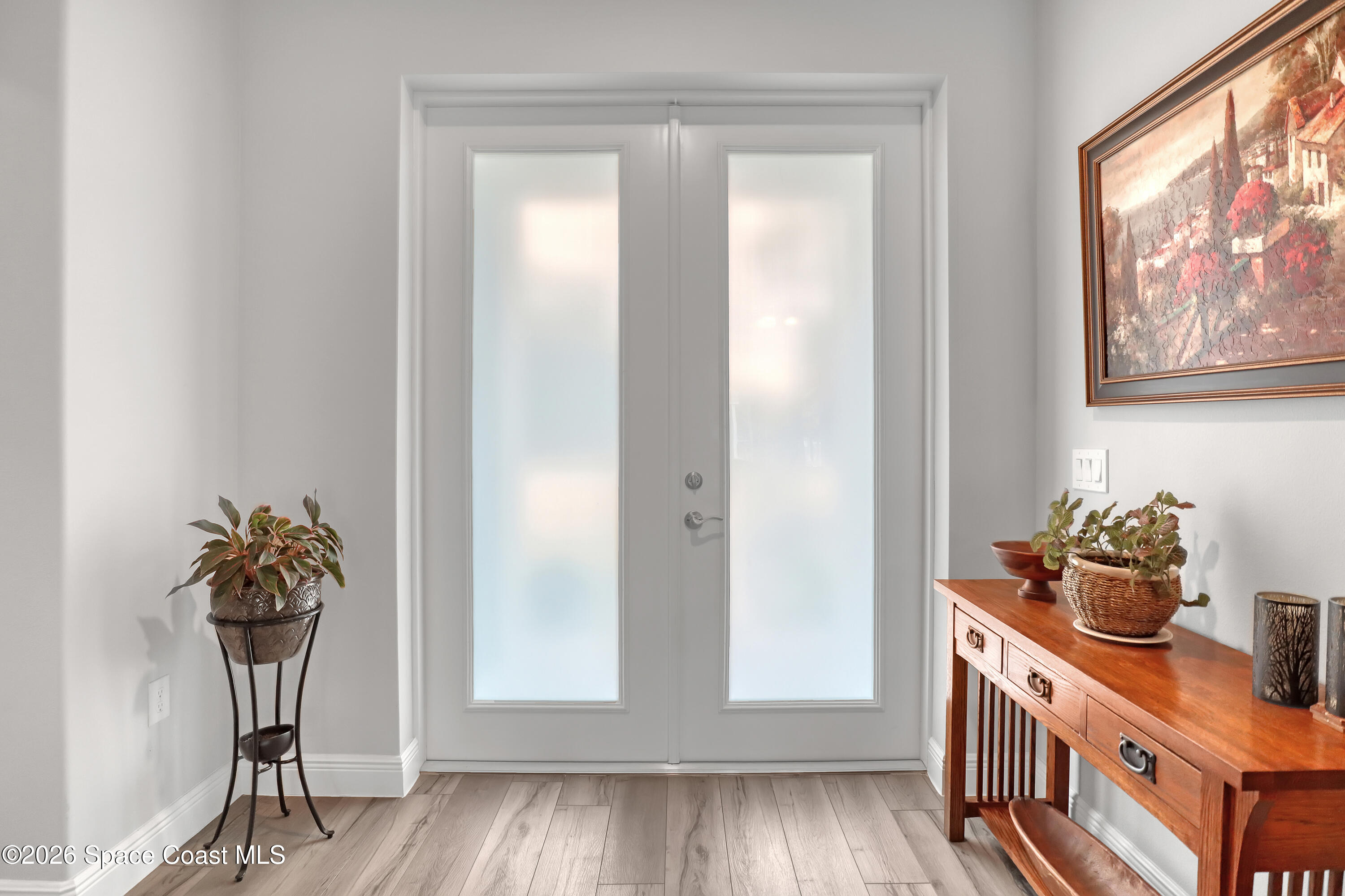 1837 Market Circle Northeast Palm Bay, FL 32905 - Photo 7 of 57 a hallway with a vase of flowers sitting on a table