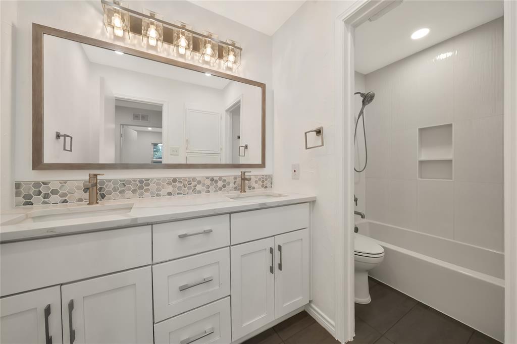 2909 Normandy Court Euless, TX 76039 - Photo 22 of 36 a bathroom with a granite countertop sink mirror and a
