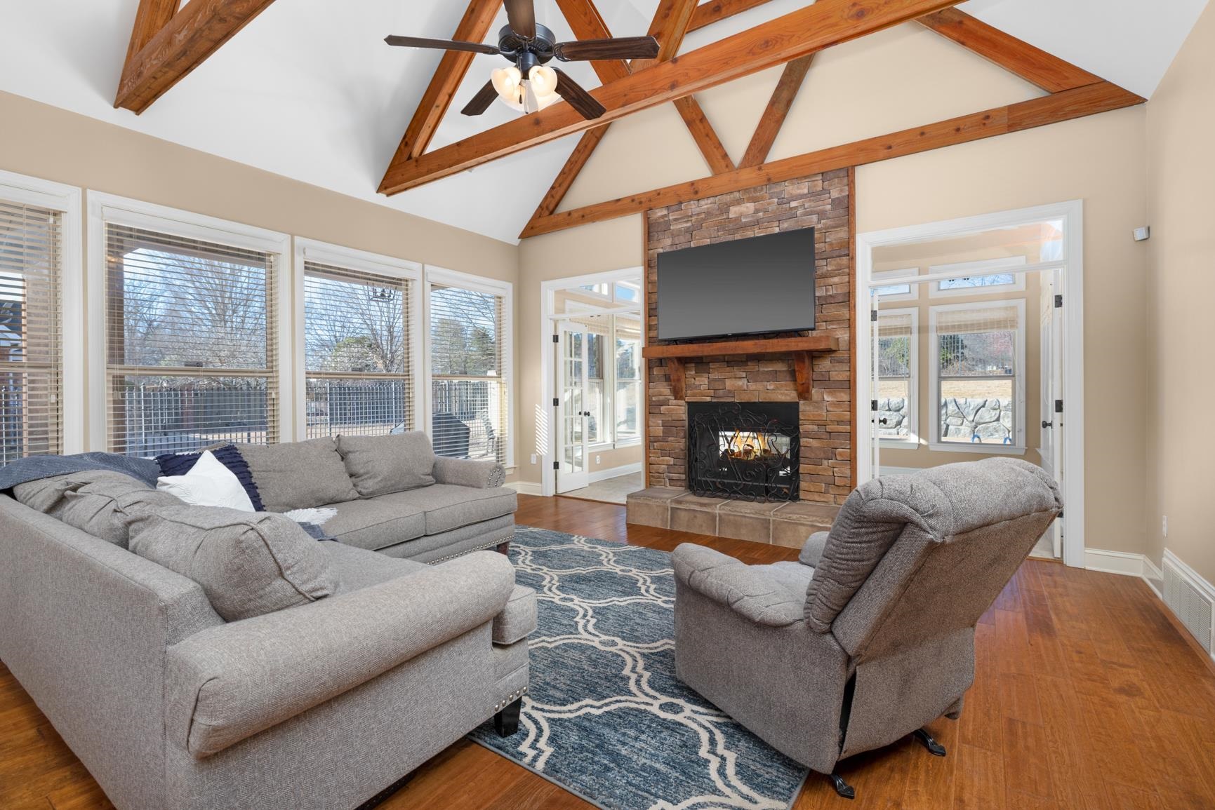 104 Eagle Trace Road Covington, TN 38019 - Photo 3 of 40 Living room with lofted ceiling, a fireplace, a ceiling fan, and wood finished floors