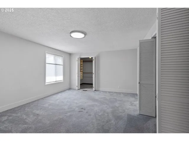 a view of an empty room with a closet