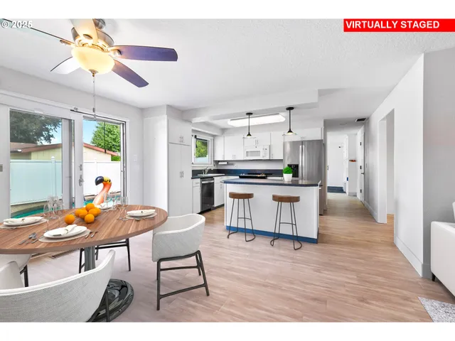 a view of a dining room with furniture and a flat screen tv