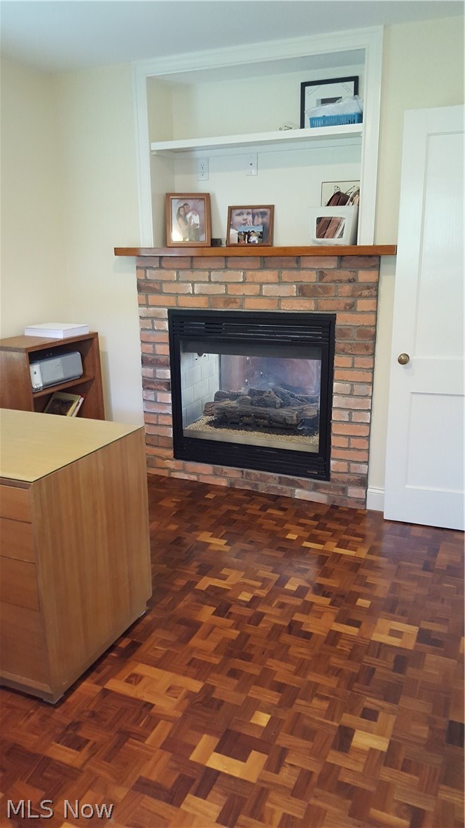 31350 Pinetree Road Cleveland, OH 44124 - Photo 12 of 33 The main floor bedroom is being used as an office. The Walnut flooring and gas fireplace make it a great home office