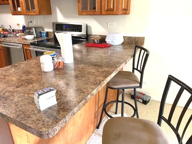 2403 South Goebbert Road, Unit 205 Arlington Heights, IL 60005 - Photo 4 of 13 a kitchen with a table chairs and a dining table