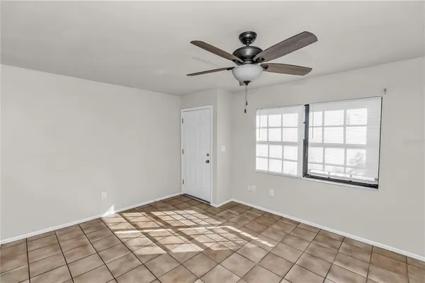 a view of a livingroom with a ceiling fan and window