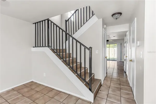 a view of a hallway with wooden floor and staircase