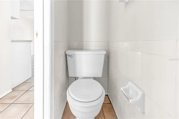 a white toilet sitting next to a white sink