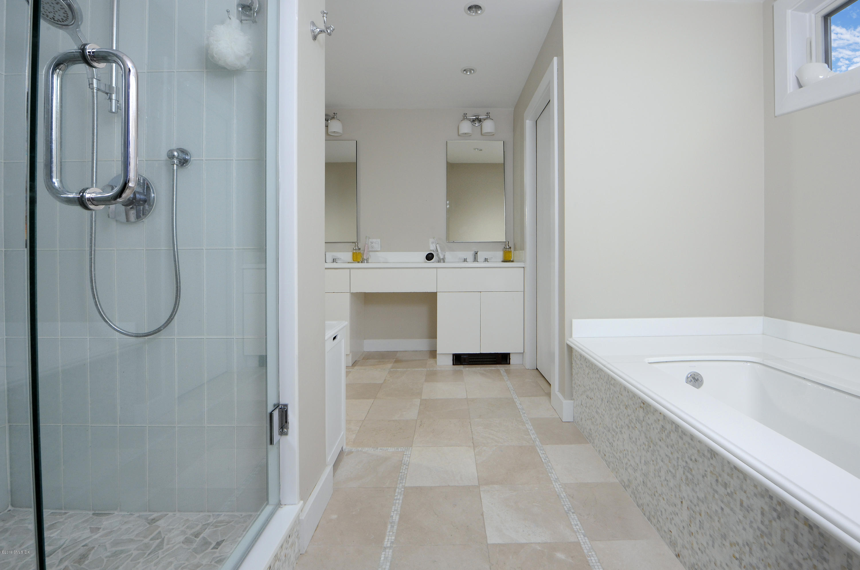 249 Shore Road Greenwich, CT 06830 - Photo 11 of 24 a bathroom with a tub sink shower and mirror