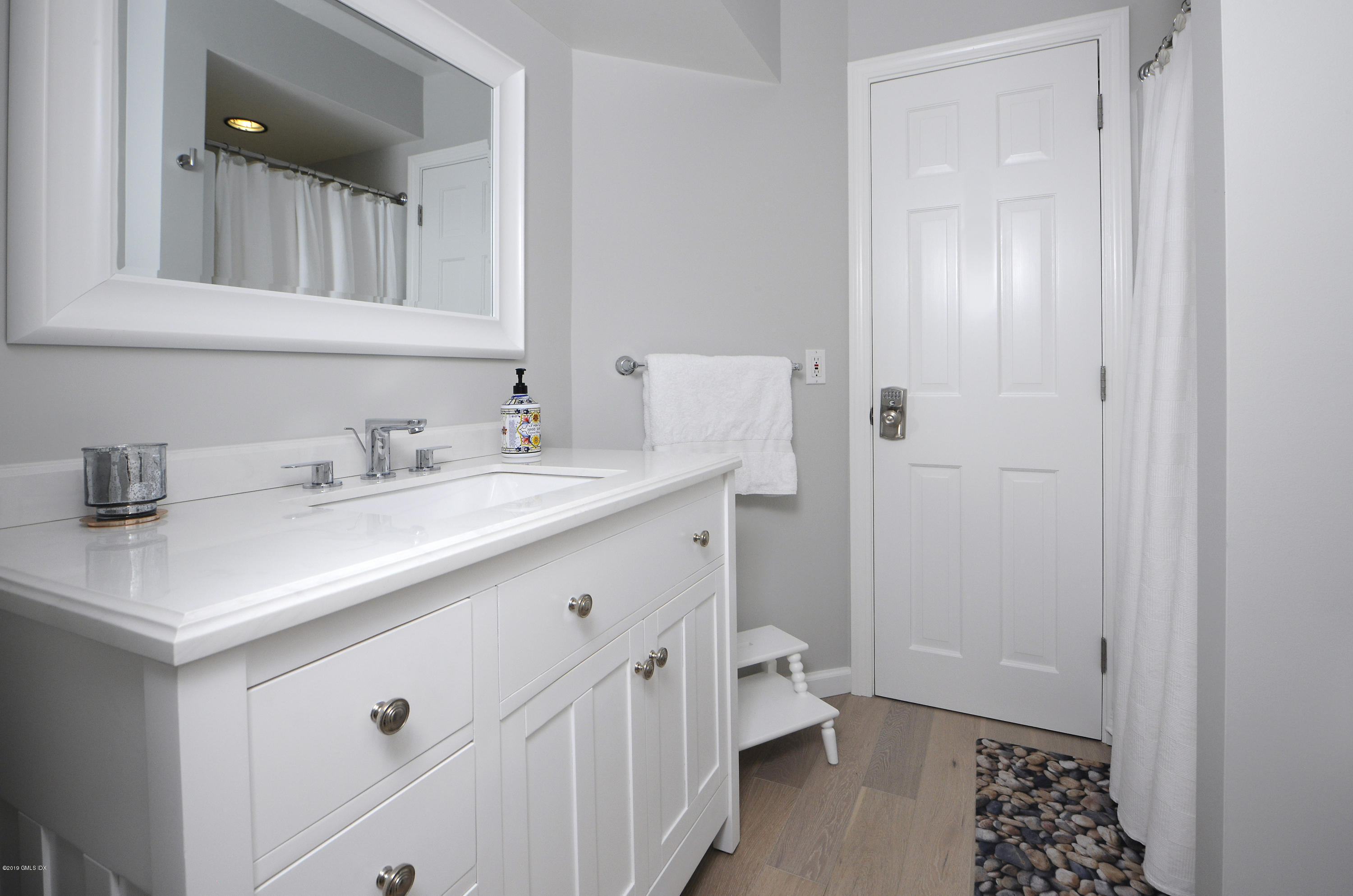 249 Shore Road Greenwich, CT 06830 - Photo 14 of 24 a bathroom with a sink a mirror and a toilet