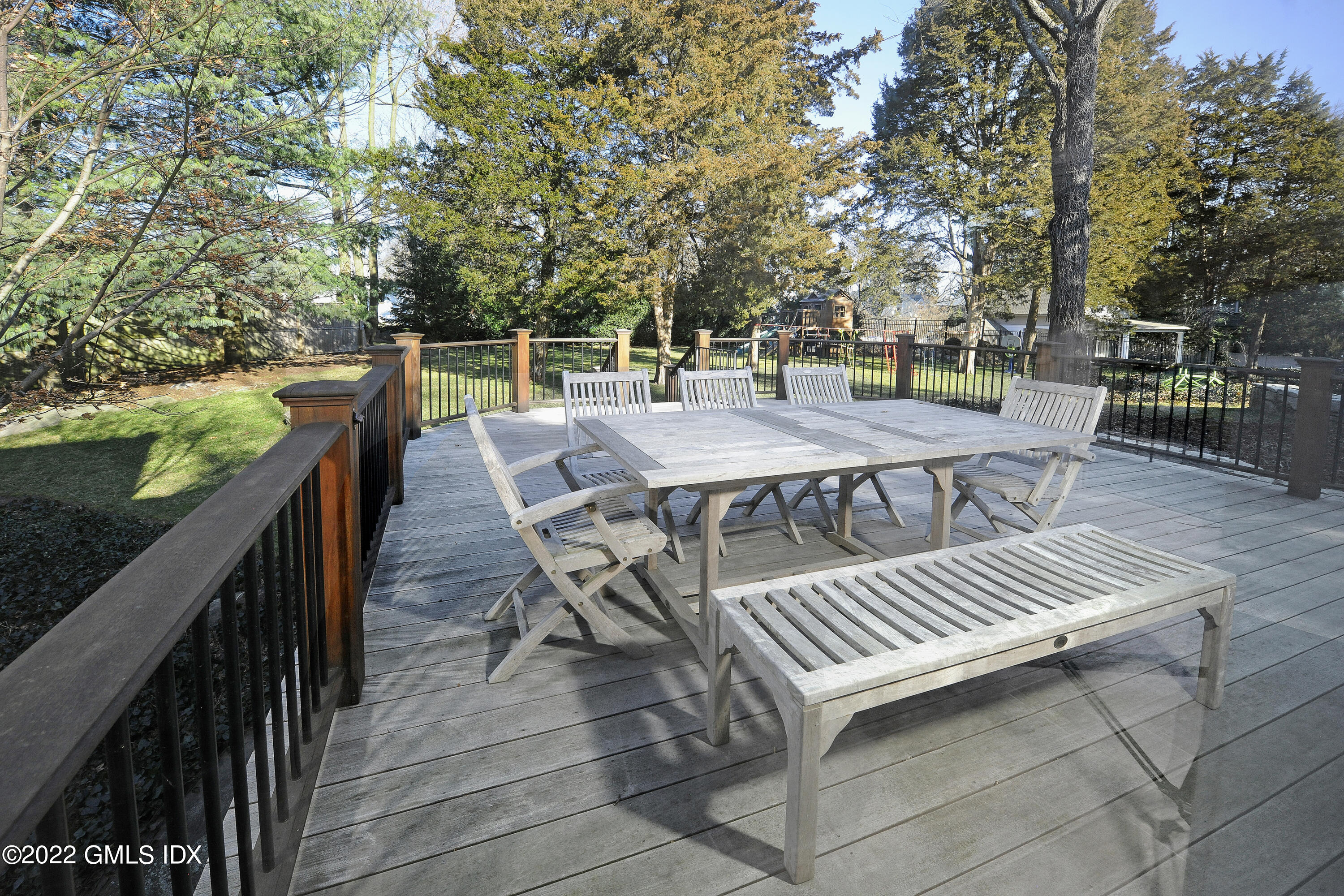 249 Shore Road Greenwich, CT 06830 - Photo 19 of 24 a view of a patio with table and chairs and wooden fence